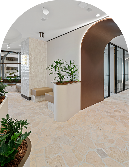 Common area at Alcove Coworking, with potted plants and an archway